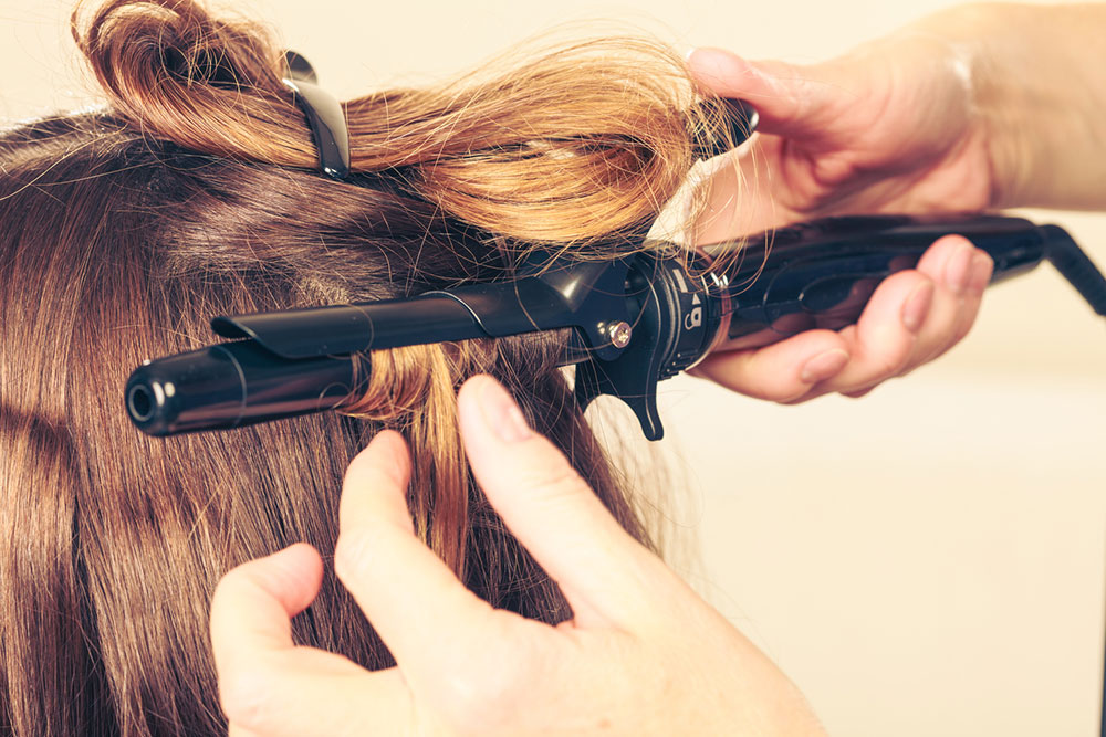 Choosing between hair rollers and curling irons